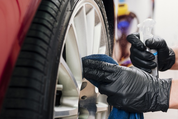 close-up-man-cleaning-car-rims_23-2148194144